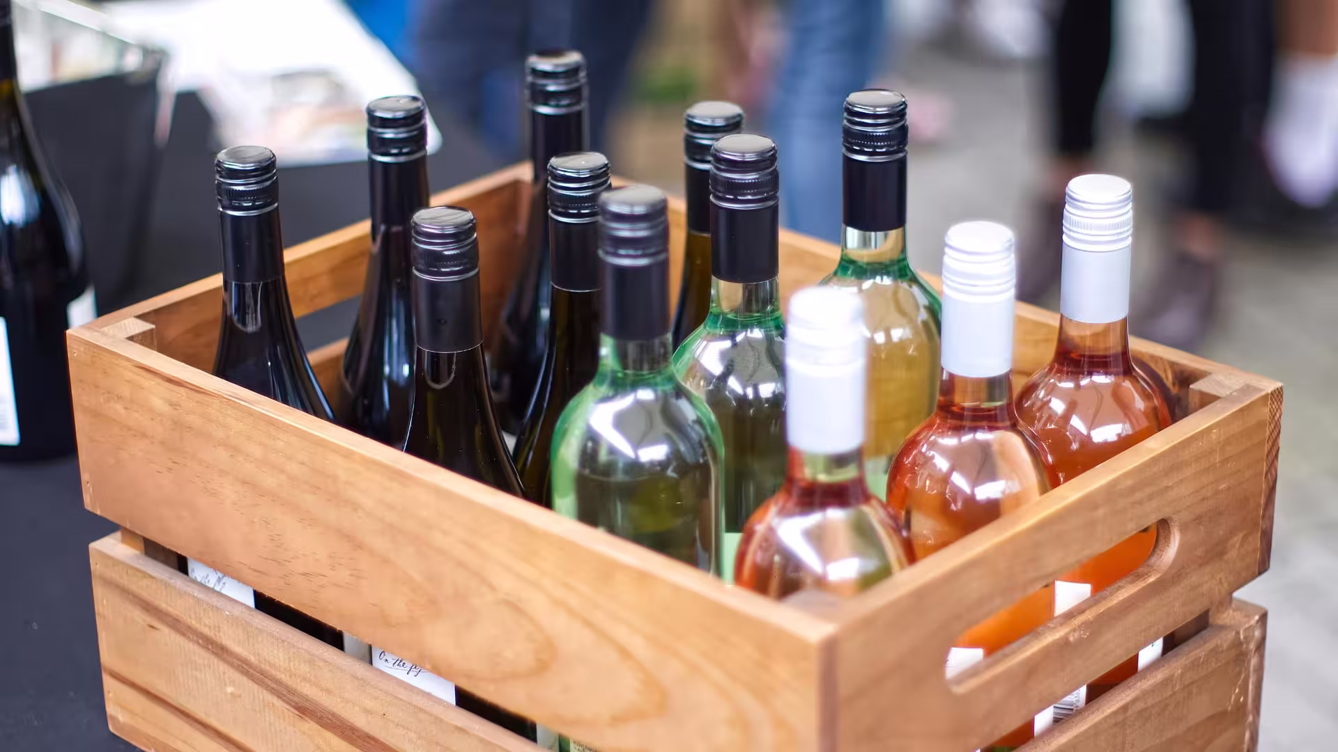 A wooden crate of wine bottles with their labels facing out